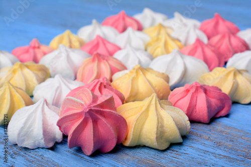 фотографія French vanilla meringue cookies on blue background.