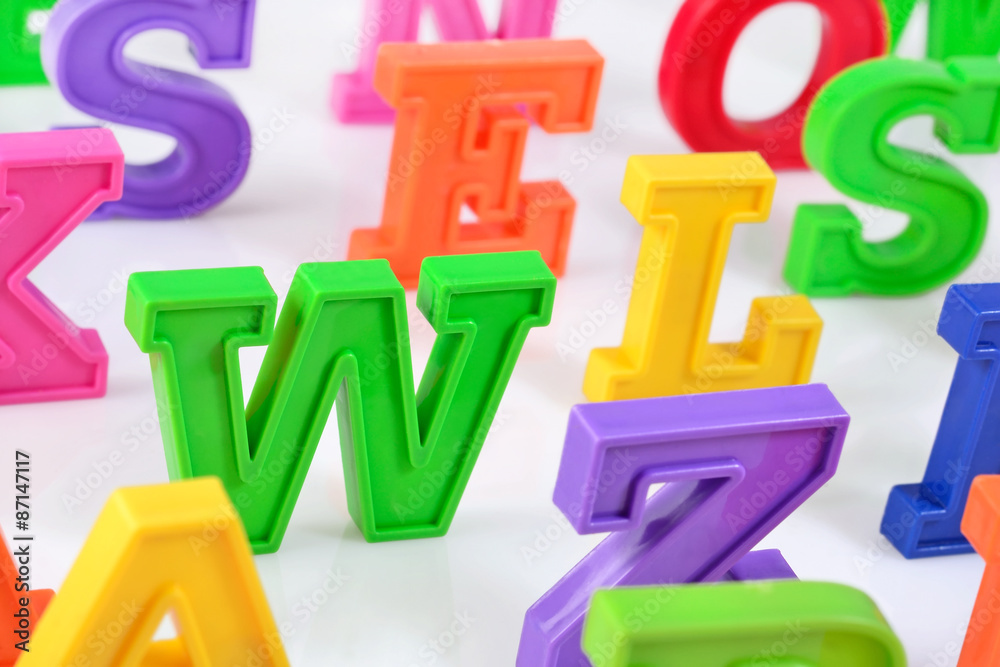 Plastic colorful alphabet letters close up on a white Plastic colorful alphabet letters close up on a white