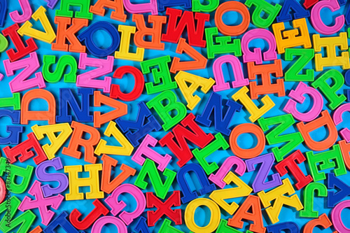 Plastic colorful alphabet letters on a blue