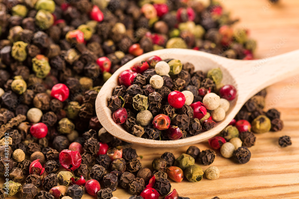 Pepper seeds in wooden spoon on wood table Pepper seeds in wooden spoon on wood table
