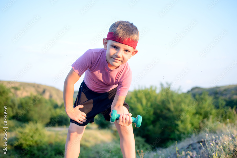 Healthy Boy Leans Forward While Lifting Weights