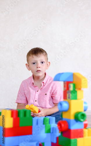 Cute Boy Playing with Colored Plastic Block Toys