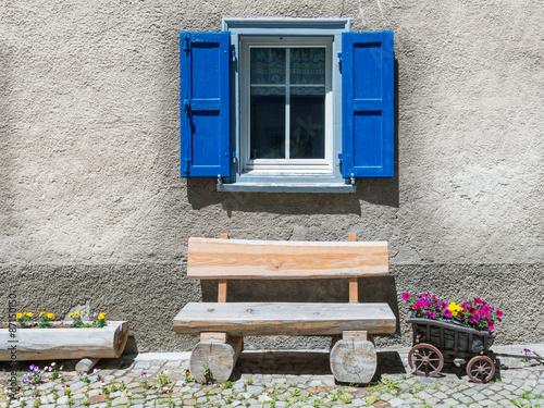 Window with flower  on ledge in a village, eastern of Switzerland. Small truck, stylized as flower pot. #87150150