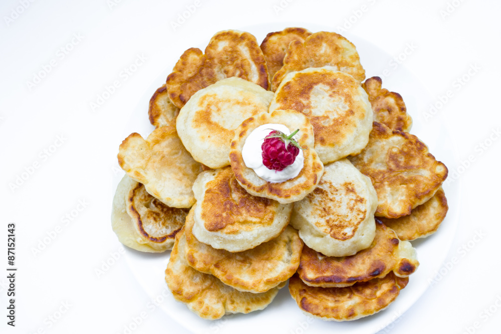 Heaps of pancakes with raspberry, top view