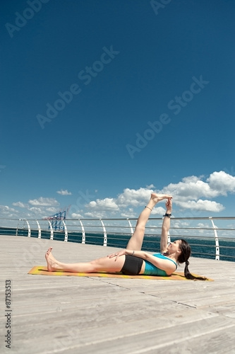 Yoga. Pose anantasana against the sea photo