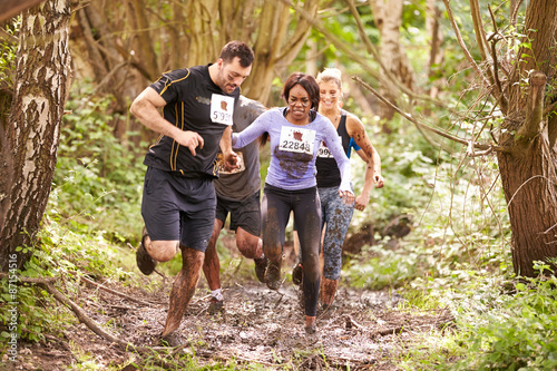 Competitors running in a forest at an endurance event