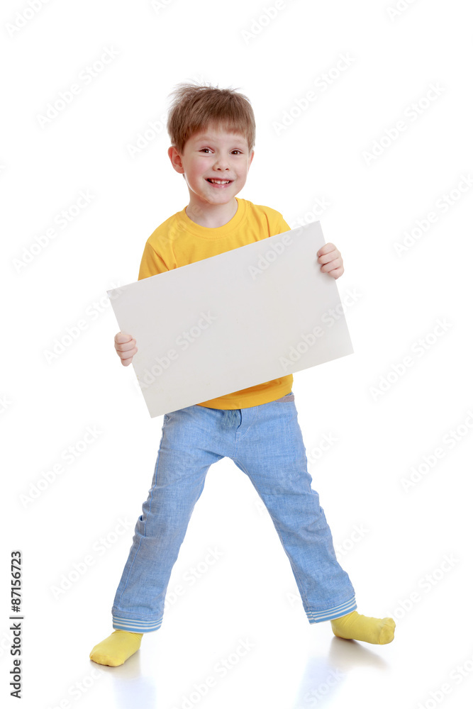 Cheerful little boy in a yellow t-shirt and jeans Cheerful little boy in a yellow t-shirt and jeans