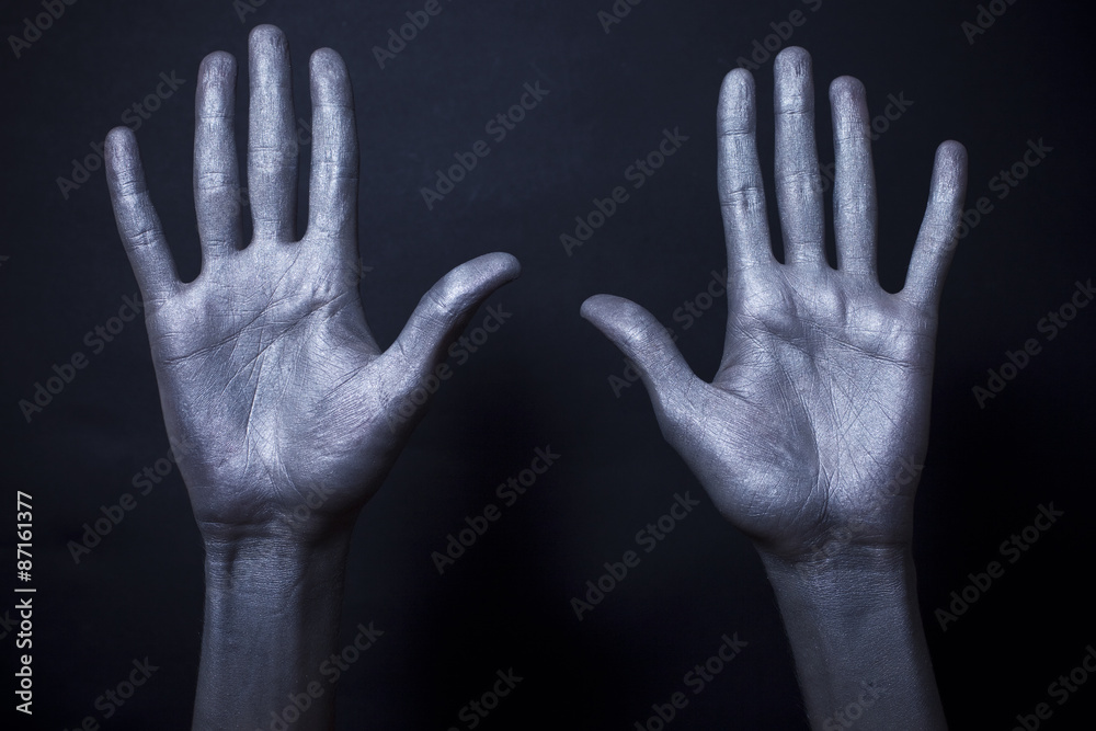  beautiful male hands in silver paint