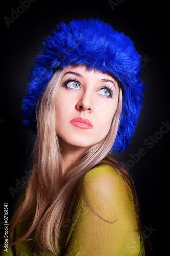Fototapeta Naklejka Na Ścianę i Meble -  beautiful young woman in blue winter hat