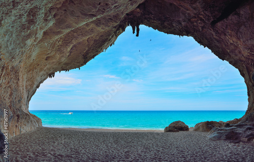 motorboat passing by a big cave in Cala Luna