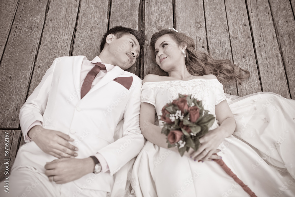 Portrait of romantic newlywed couple lying down together