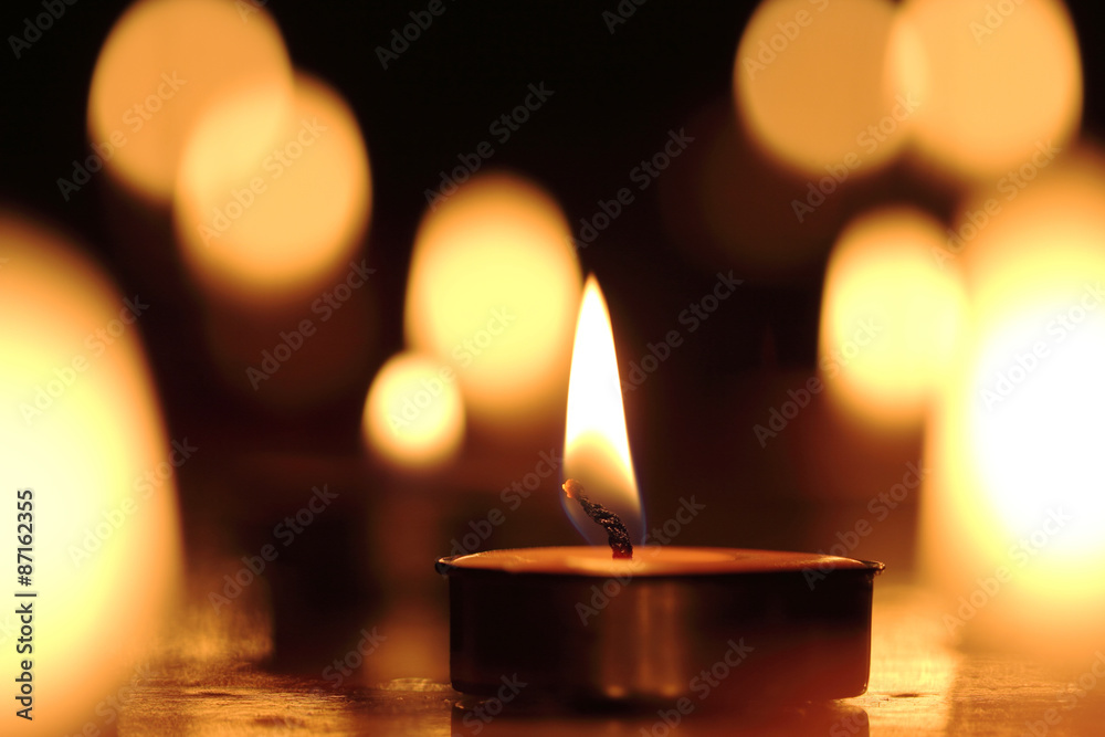 Candles light select focus, black background.
