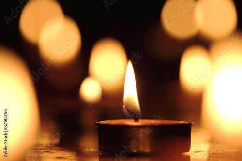 Candles light select focus, black background.