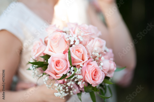 Bride holding big wedding bouquet before ceremony