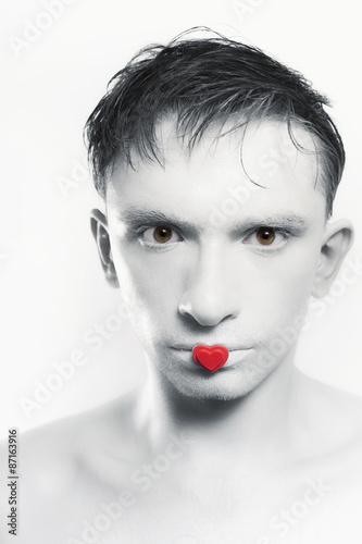 young brunette man with white skin and red heart on  lips