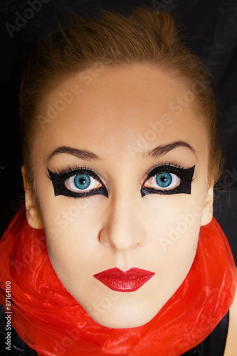 Portrait of beautiful young woman with bright makeup