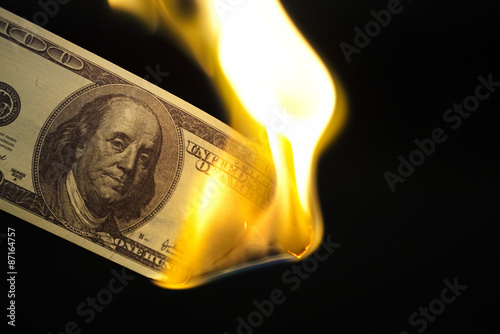Image of 100 bill burning