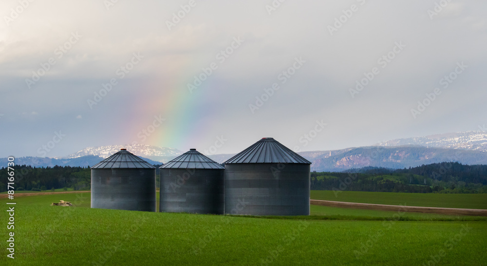 three silos and rainbow in agriculture land three silos and rainbow in agriculture land