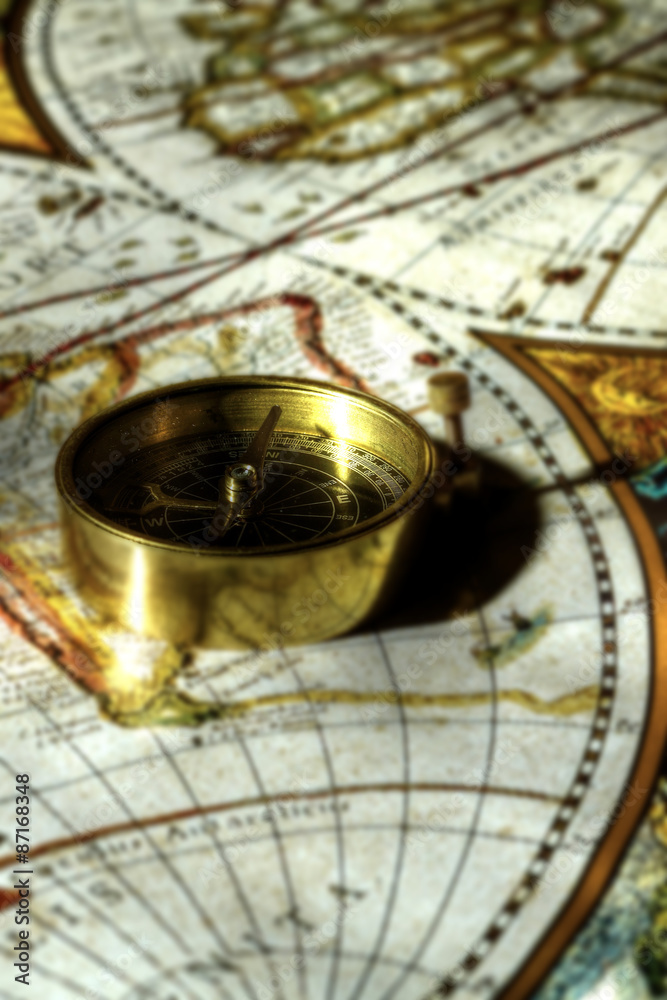 Antique compass on map.
Antique brass compass on an old map.