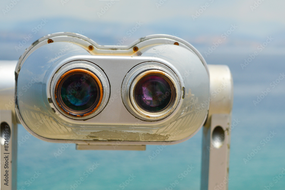 Public binoculars looking at the clear blue sea