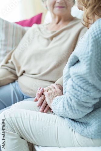 Woman holding aged female