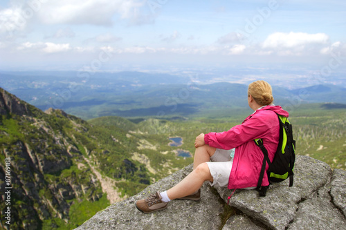 hiker relaxing on the mountain rock
