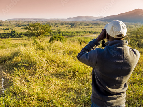 Papier peint South Africa, ranger looking through binoculars in search of animals during a sa