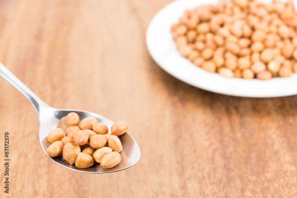 peanuts without shell on wooden background peanuts without shell on wooden background