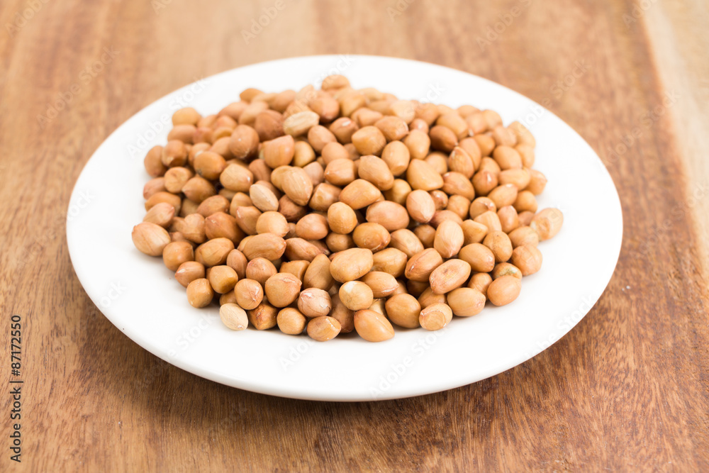 peanuts without shell on wooden background peanuts without shell on wooden background