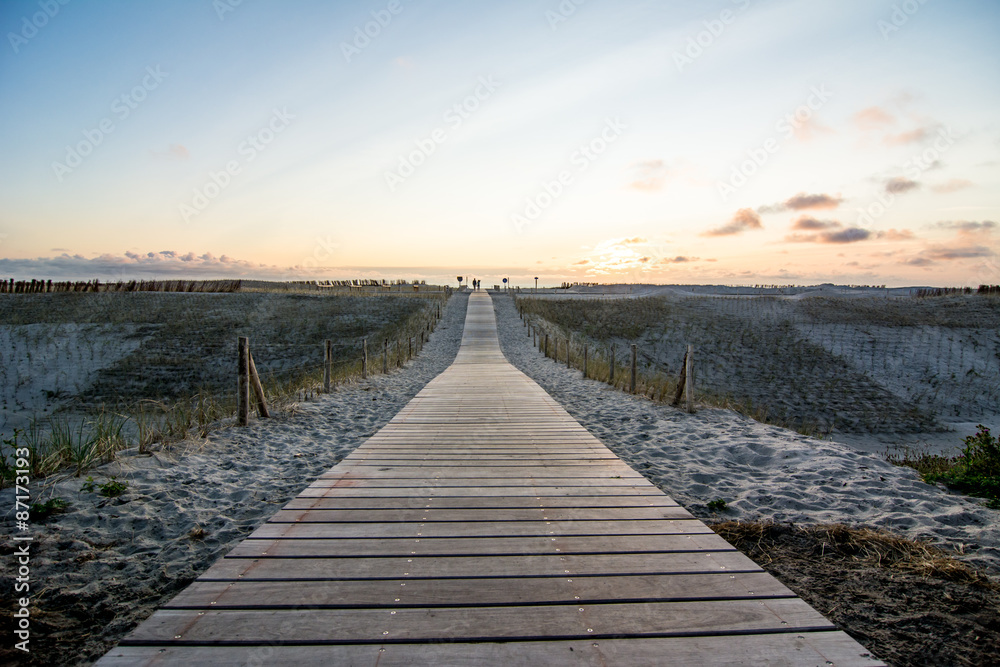 wooden walkway to beach at sunset
