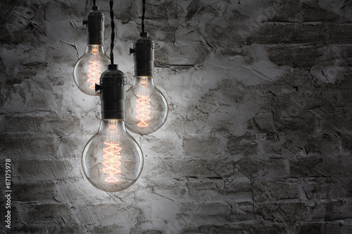 Idea concept - Vintage incandescent bulbs on wall background