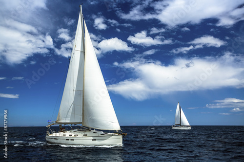 Fototapeta Naklejka Na Ścianę i Meble -  Ship yachts with white sails in the open sea. Sailing. Yachting. Luxury Lifestyle.