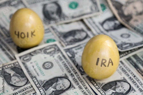 Retirement golden eggs on dollars, IRA in focus, 401k blurry