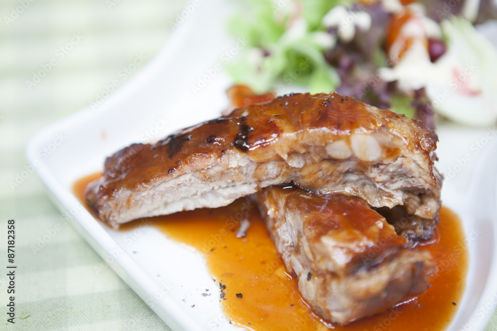Pork rib stack with red sauce with salad Pork rib stack with red sauce with salad