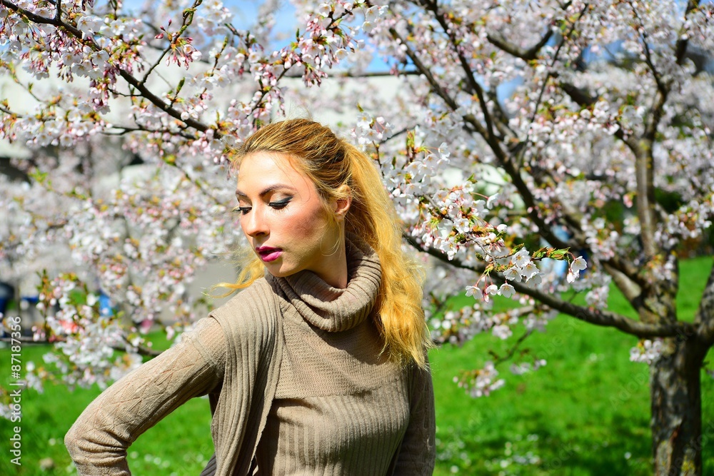 Young girl posing in the sakura garden Young girl posing in the sakura garden
