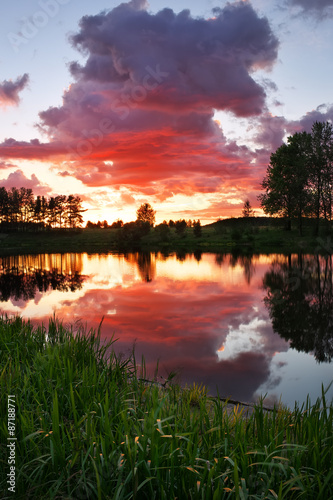 Beautiful landscape with fiery sunset over the lake in the villa