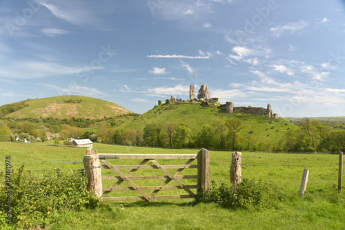 Corfe Castle seen across fields in Dorset