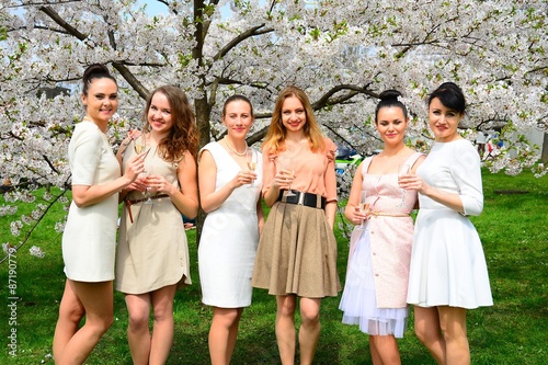 Girls with champagne celebrating in sakura's garden.