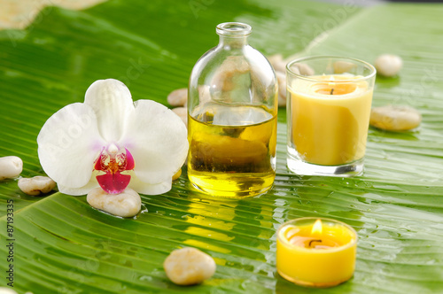 White Orchid and candle  stone on banana leaf background