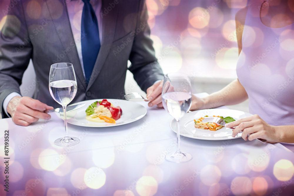 close up of couple eating appetizers at restaurant close up of couple eating appetizers at restaurant