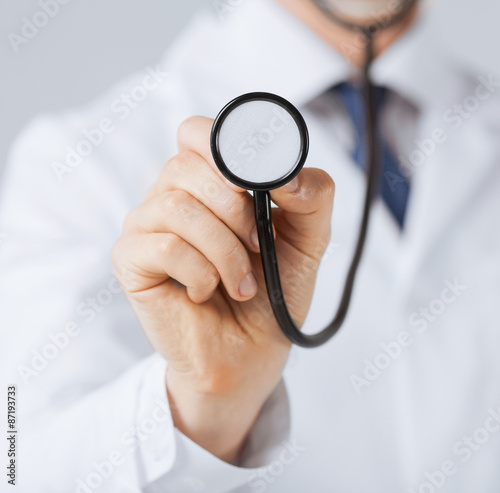 doctor hand with stethoscope listening something