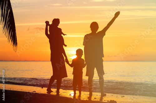 happy family with two kids having fun at sunset