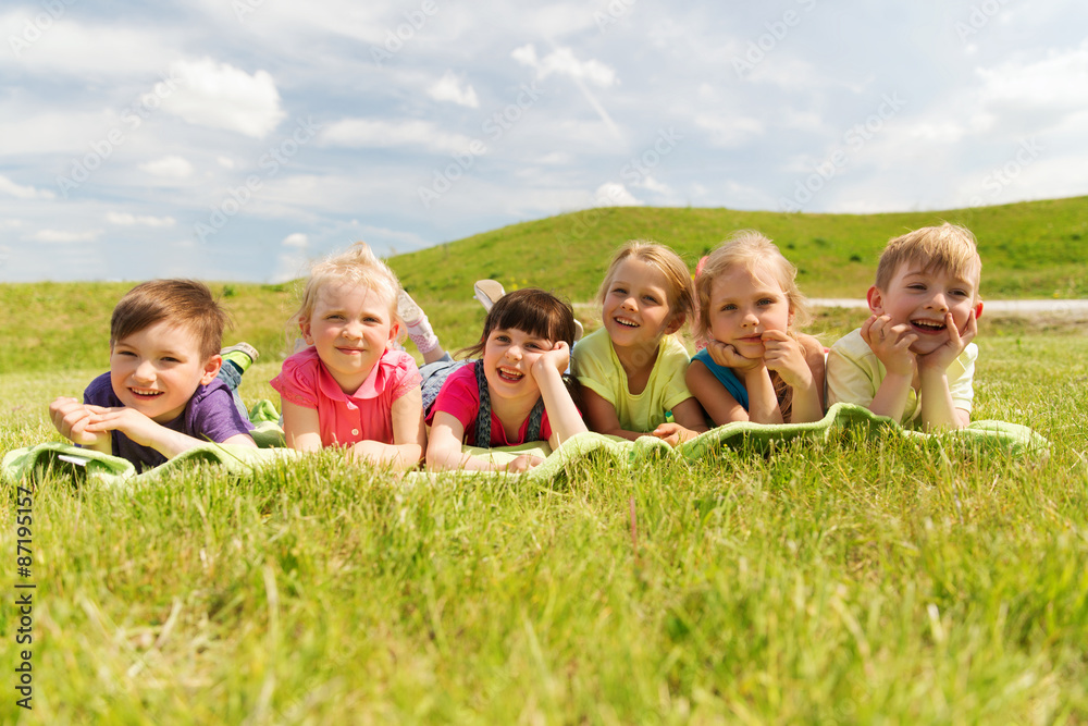 group of kids lying on blanket or cover outdoors group of kids lying on blanket or cover outdoors