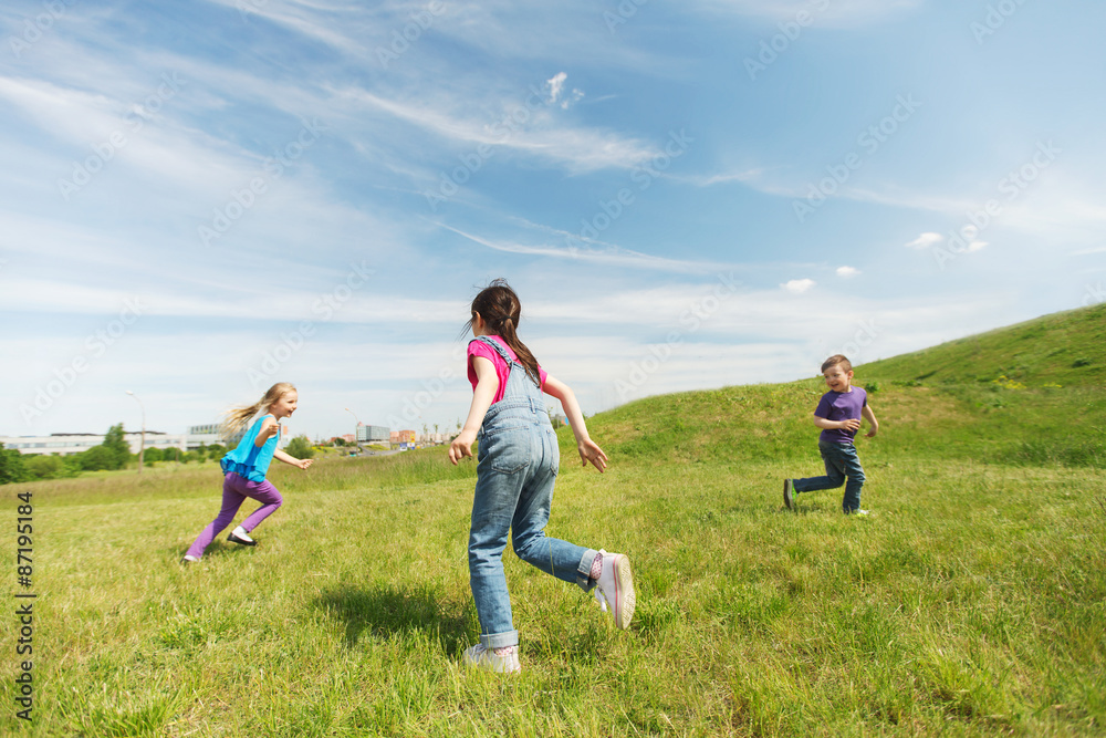 group of happy kids running outdoors