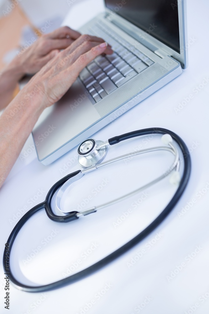 Close up view of female doctor using laptop Close up view of female doctor using laptop