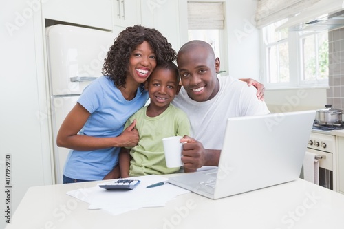 Portrait of a happy smiling family using computer 