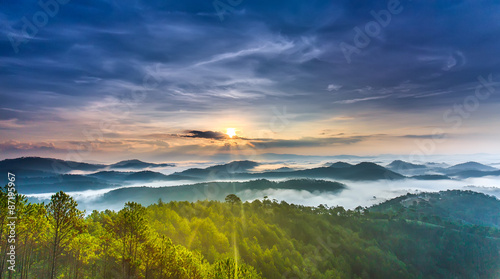 Sunrise on the Da Lat plateau with clouds around the mountains on the small village beneath a warm picture of a beautiful new day