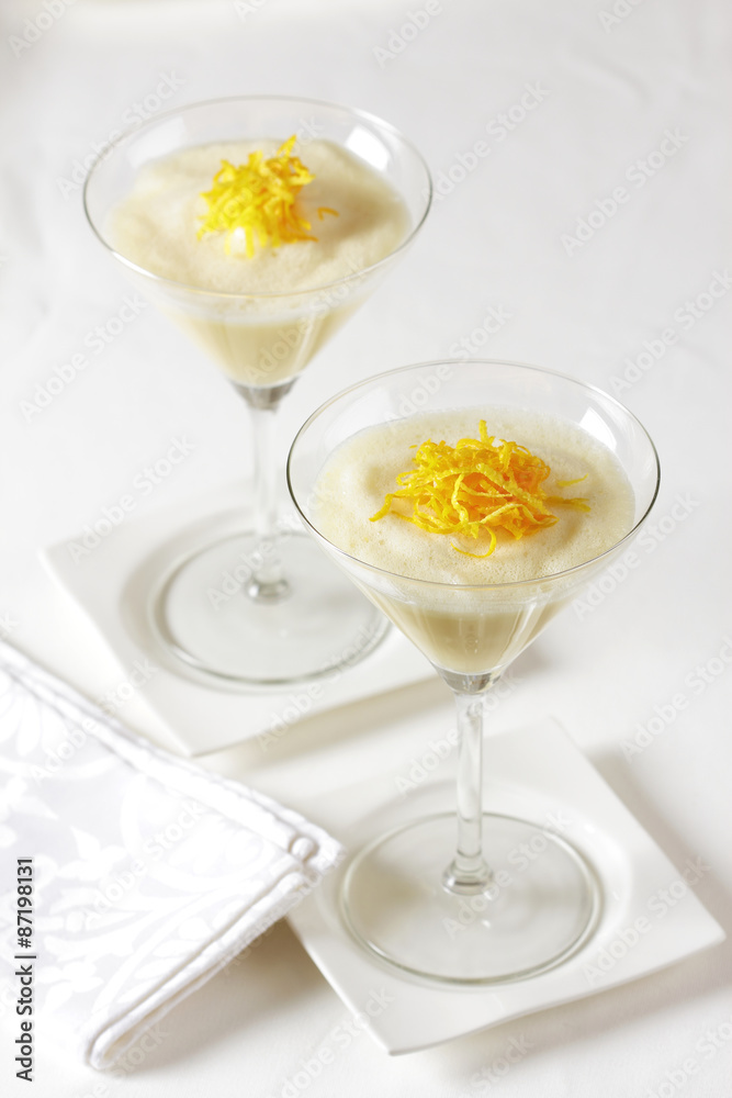 Lemon and orange dessert in high glasses. Lemon and orange dessert in high glasses.