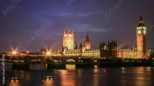 Houses of Parliament at night. Night view of the seat of UK government  The Houses of Parliament  viewed from across the River Thames and with Westminster Bridge in the foreground.