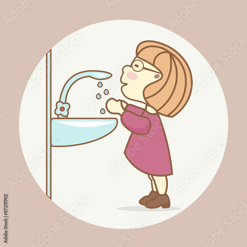 Compliance with the rules of sanitation and hygiene: a girl washes her hands in the bathroom